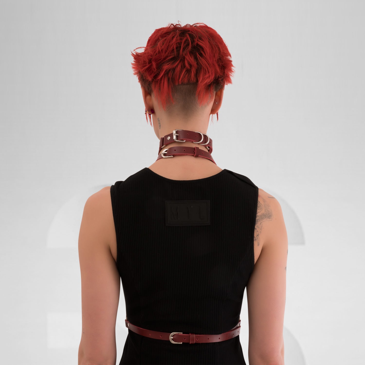 Red wine leather waist harness with silver details, perfect for a techno club scene outfit