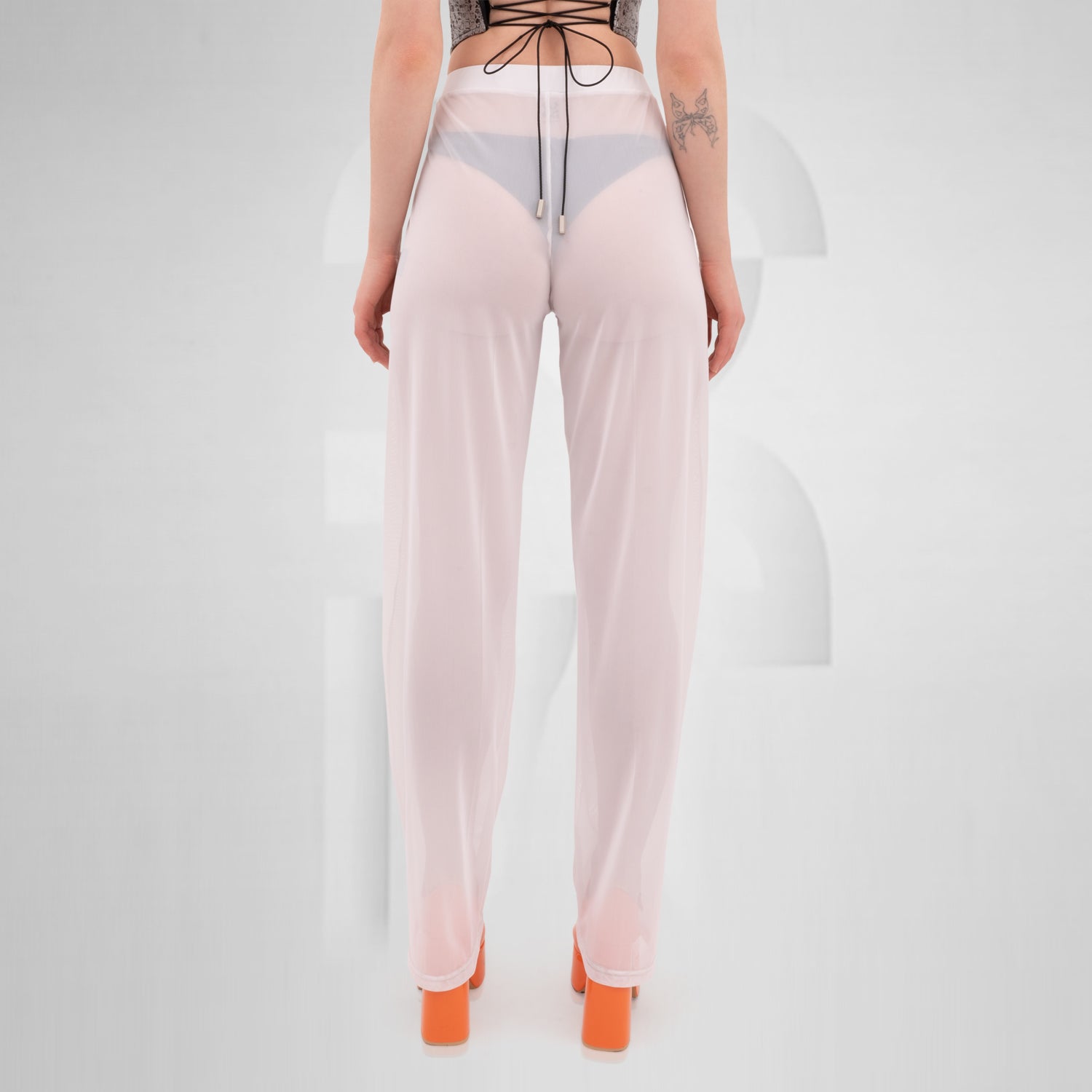 White Pants from THE CODE displayed on a model, showcasing their stylish, breathable design ideal for summer and nightlife.