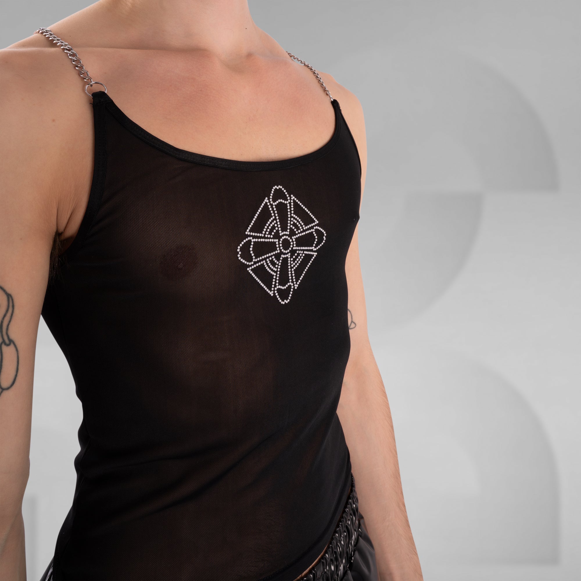Black tank top with decorative bow design on a neutral background