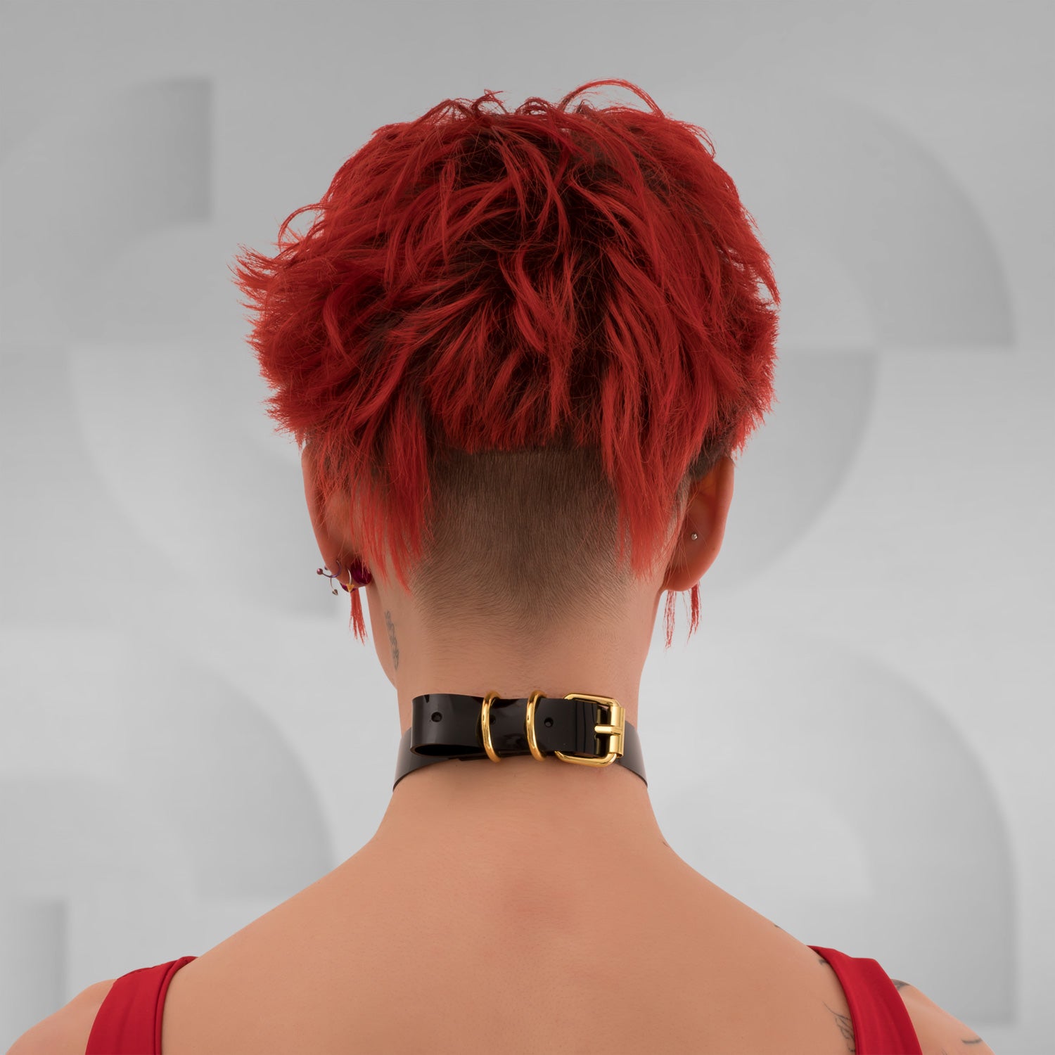 A close-up of the Minimalist Black PVC Choker from Miss Overdose, showcasing its bold oversized ring in gold. The choker, crafted from sleek leather, embodies a blend of elegance and playful kink, perfect for clubwear, adding a striking touch to any outfit.