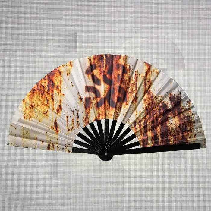 The Printed Rusty Dance Floor Fan from The Code showcases a unique design that combines rustic textures with a modern aesthetic. Featuring a striking blend of earthy tones and eye-catching patterns, this fan not only provides a refreshing breeze as you dance but also serves as an unforgettable accessory that enhances any outfit. Lightweight and easy to carry, it's the perfect companion for your nights out, allowing you to express your distinctive style while staying comfortable. Ideal for fashion enthusiast