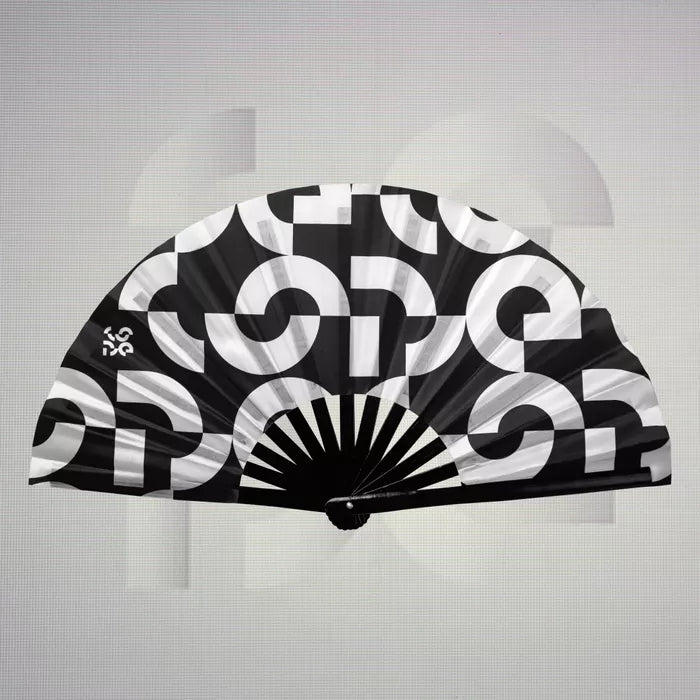 The Printed Dance Floor Fan from The Code features a striking black-and-white design that embodies contemporary style and artistic expression. This fan, adorned with bold graphics and the brand's signature logo, is not only a functional accessory for keeping cool on the dance floor but also a statement piece that enhances any outfit. Its spacious silhouette and lightweight construction make it ideal for lively nights out, allowing you to effortlessly showcase your flair while enjoying refreshing comfort. El