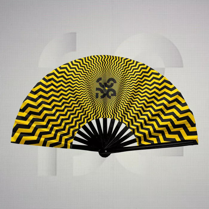 The Printed Trippy Dance Floor Fan from The Code features a striking design in vibrant yellow and bold black, creating a mesmerizing optical illusion that captures attention. This fan serves as both a functional accessory and a stylish statement piece, perfect for adding flair to your clubwear. Its lightweight construction allows for easy handling, ensuring you stay cool while dancing the night away. Embrace its unique patterns as a reflection of your individual style and let it elevate your nightlife exper