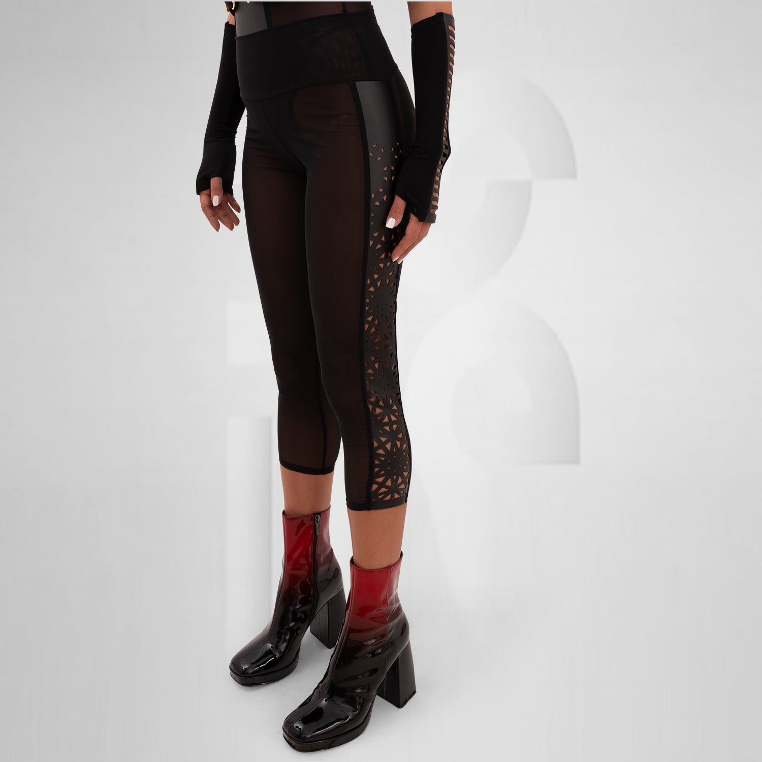 Sheer mesh leggings featuring a laser-cut panel with a psychedelic pattern, designed for bold self-expression and perfect for festivals, nightlife, and avant-garde outfits.