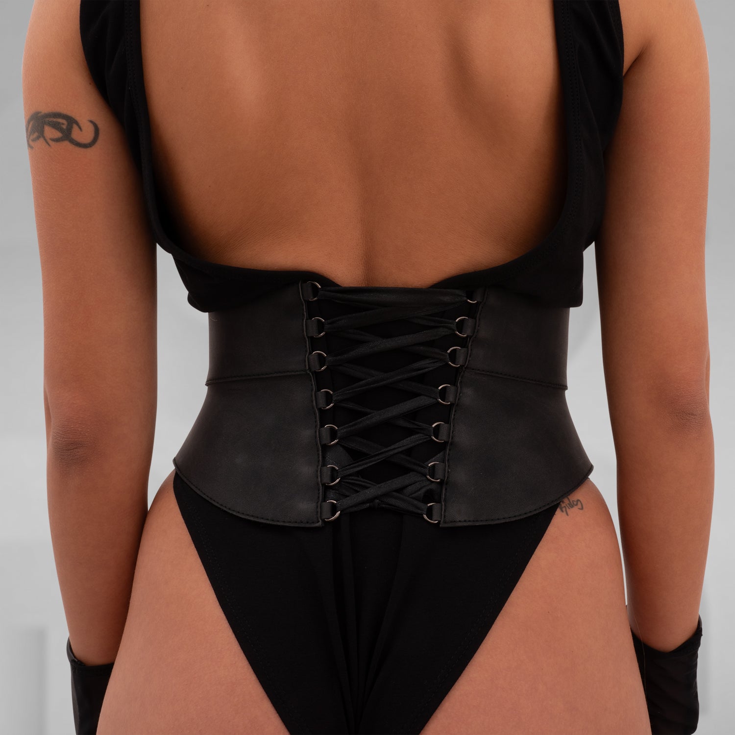 Elegant corset crafted from durable vegan leather, featuring adjustable lacing, detachable rubber tassels, and a structured yet comfortable fit, perfect for bold self-expression.