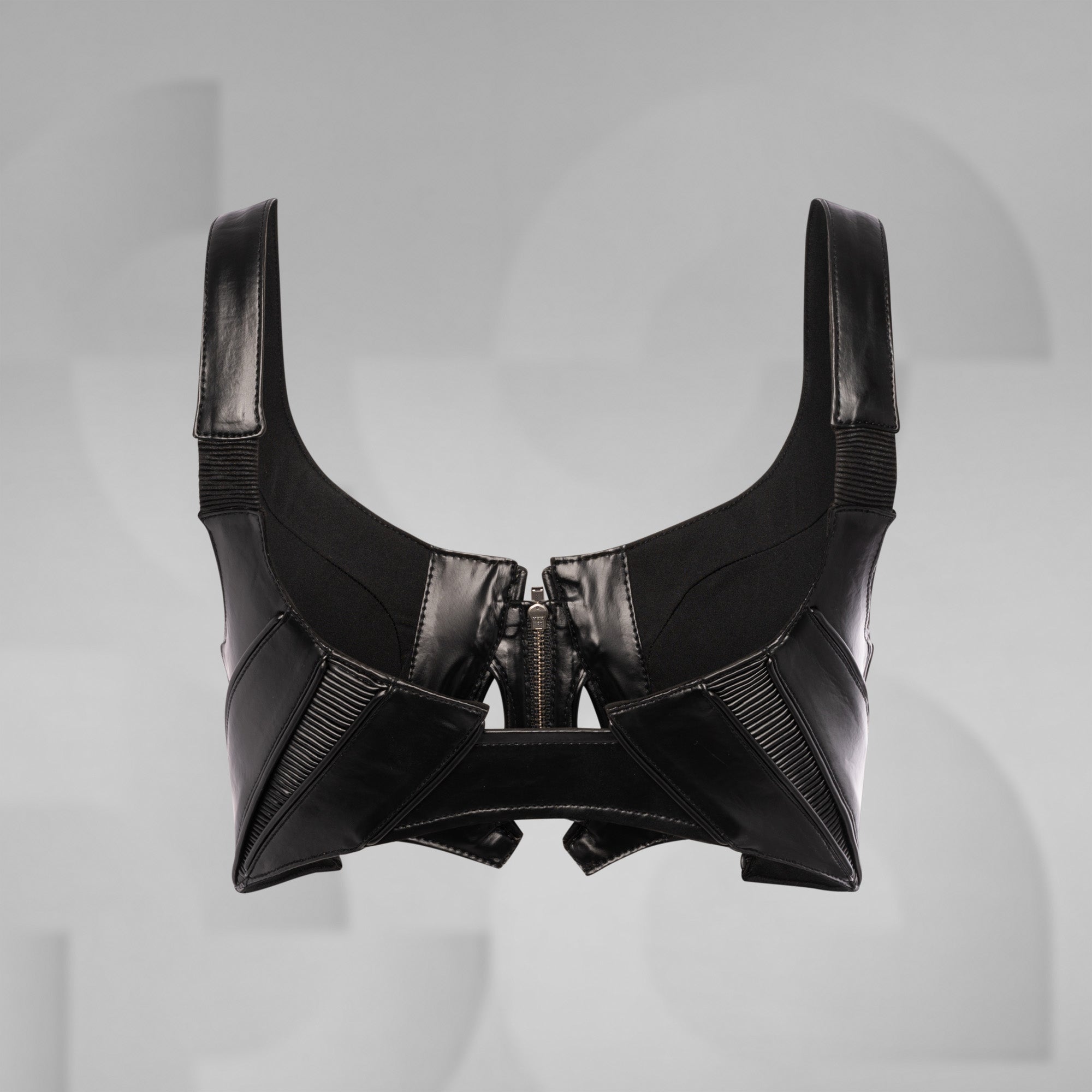 Black leather harness on a gray background