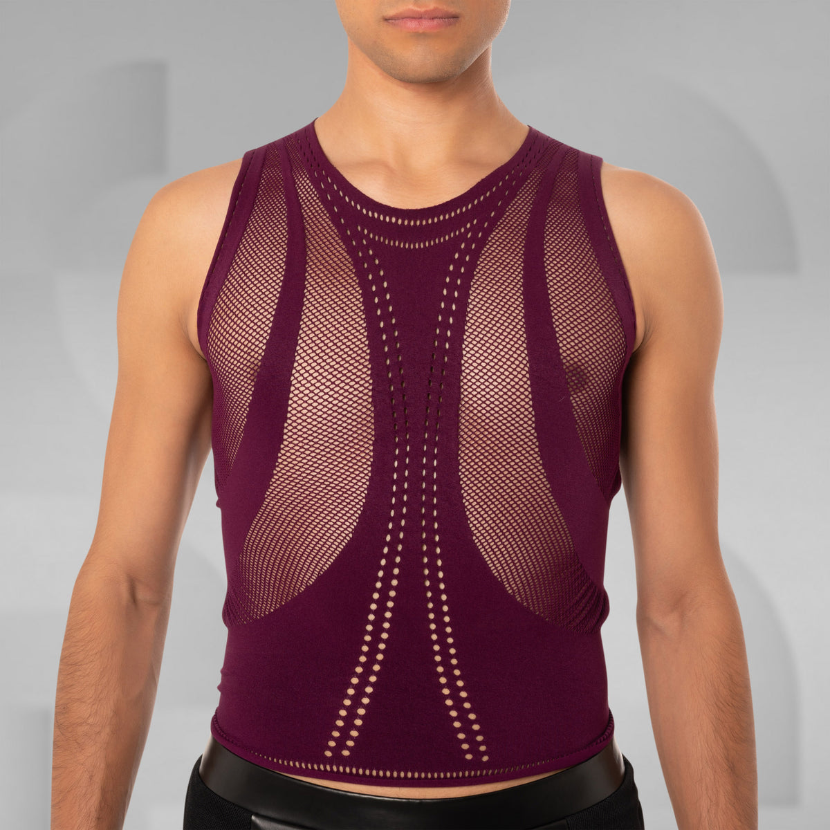 A man wearing a sleeveless burgundy mesh compression vest with a structured, fitted design and dotted pattern details on a gray studio background.
