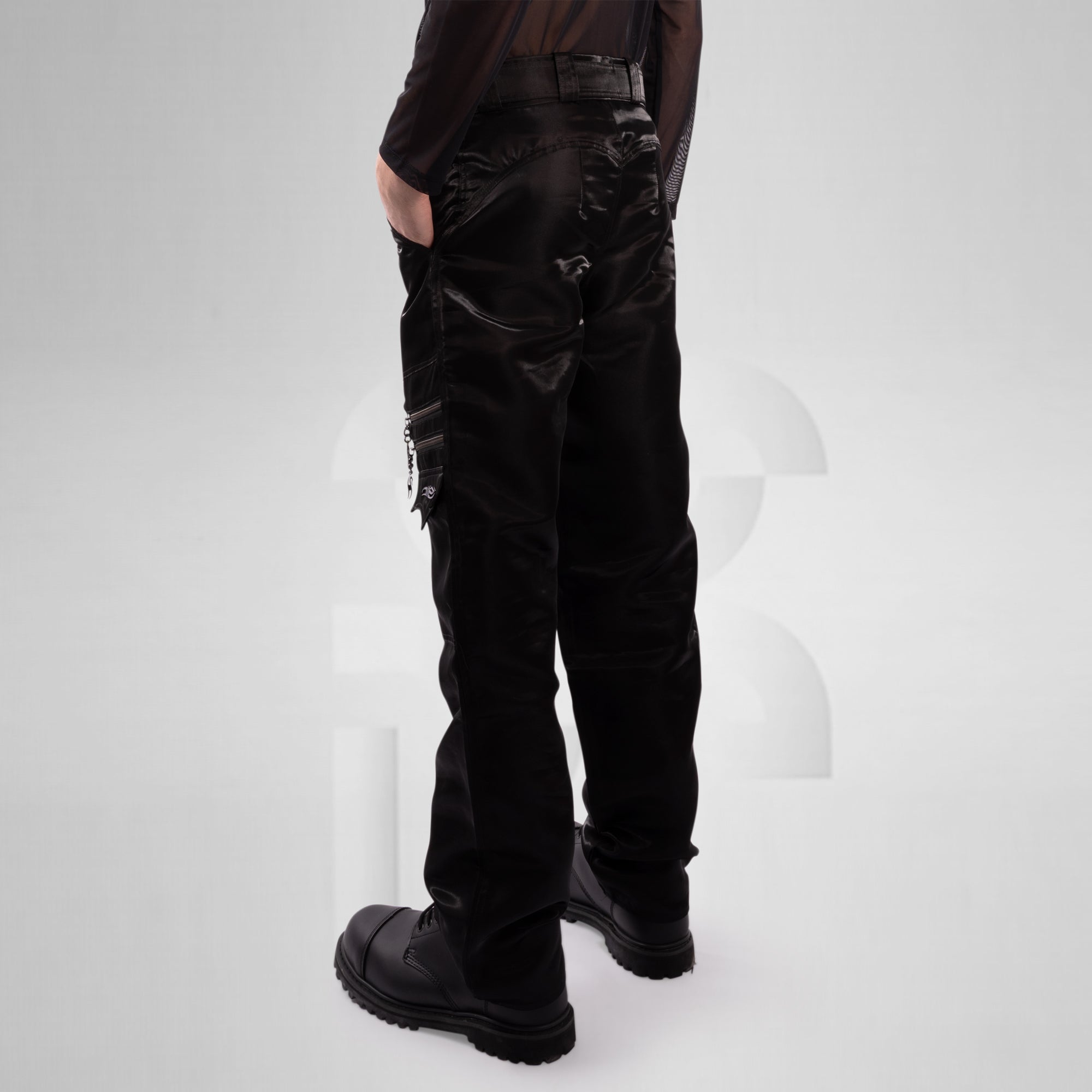 Person wearing black cargo pants on a white background