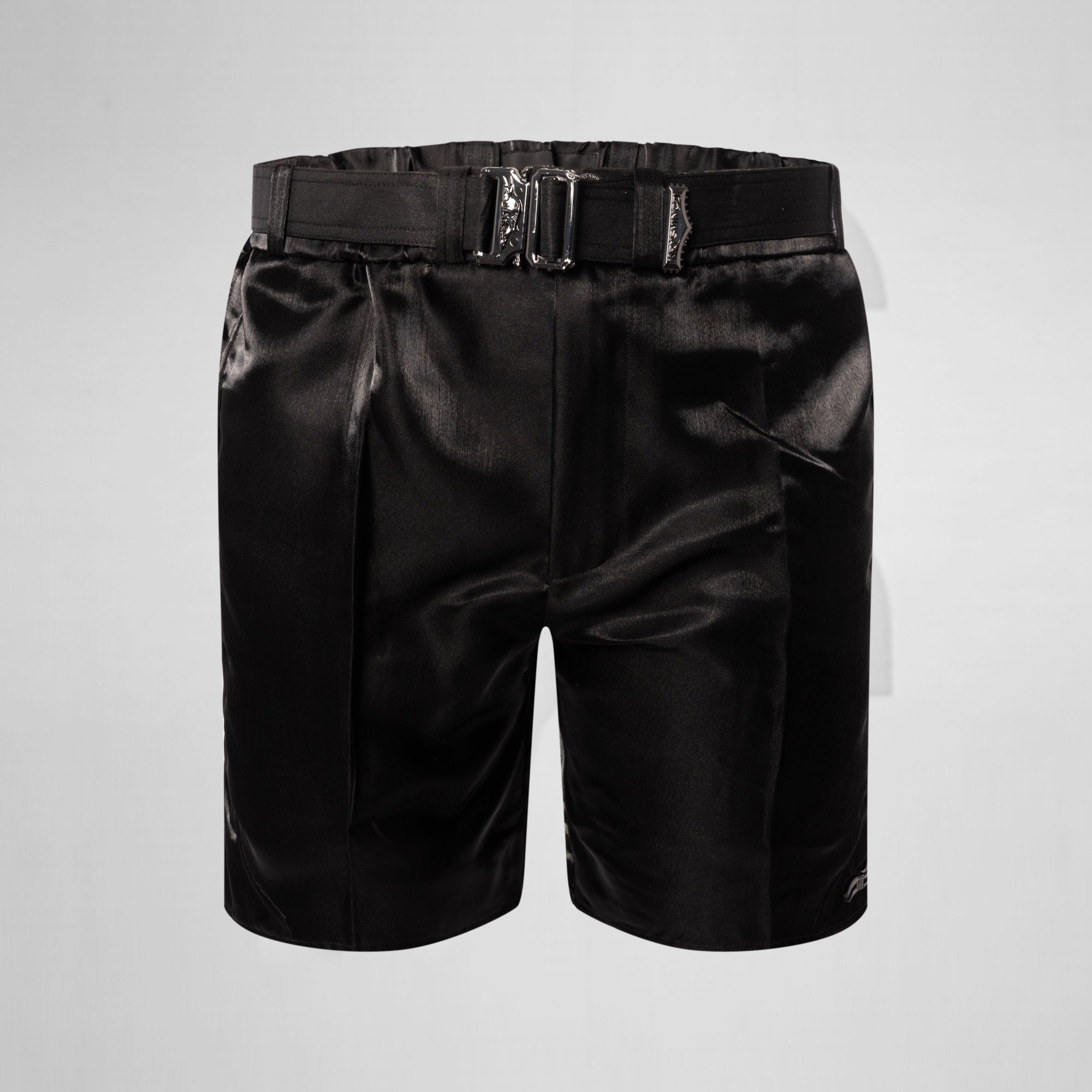 Black satin shorts with a belt on a light gray background