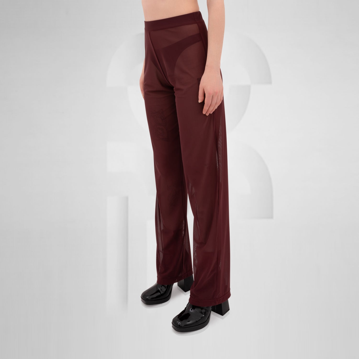 Gender-neutral red mesh pants with a relaxed fit, designed for the Berlin club scene and modern clubwear fashion.