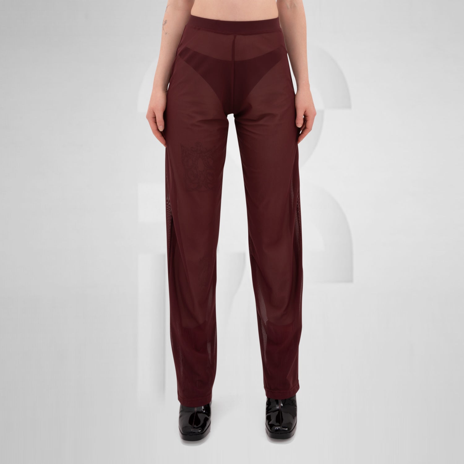 Gender-neutral red mesh pants with a relaxed fit, designed for the Berlin club scene and modern clubwear fashion.