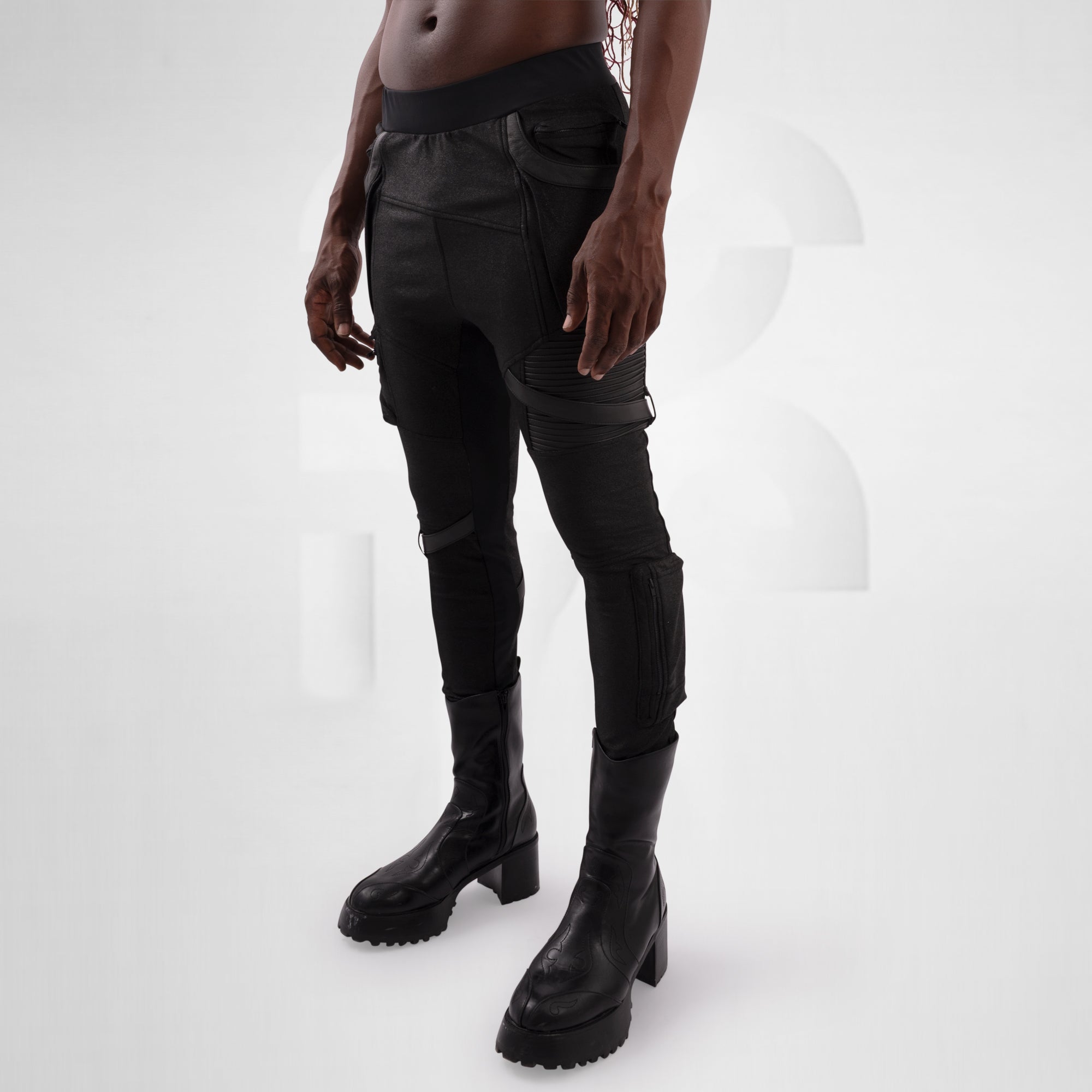 Person wearing black cargo pants and boots on a white background