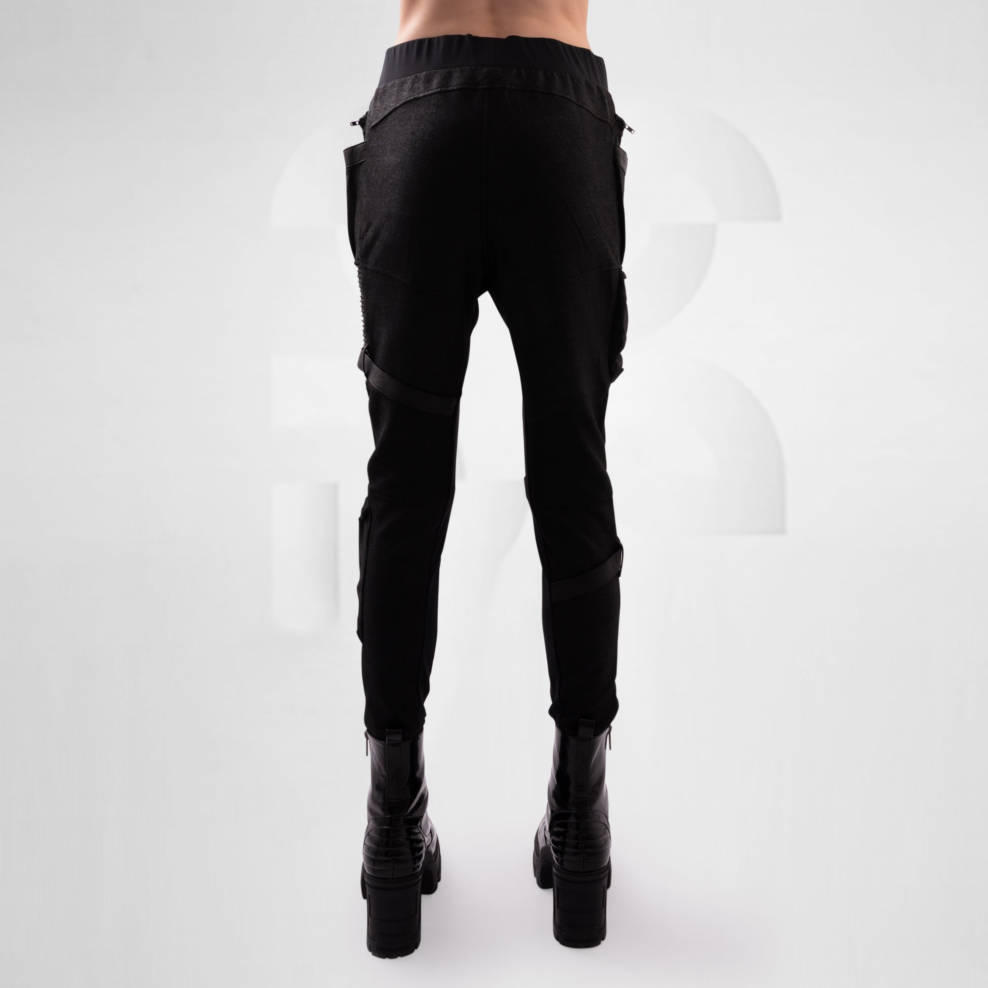 Black cargo pants worn by a person on a white background