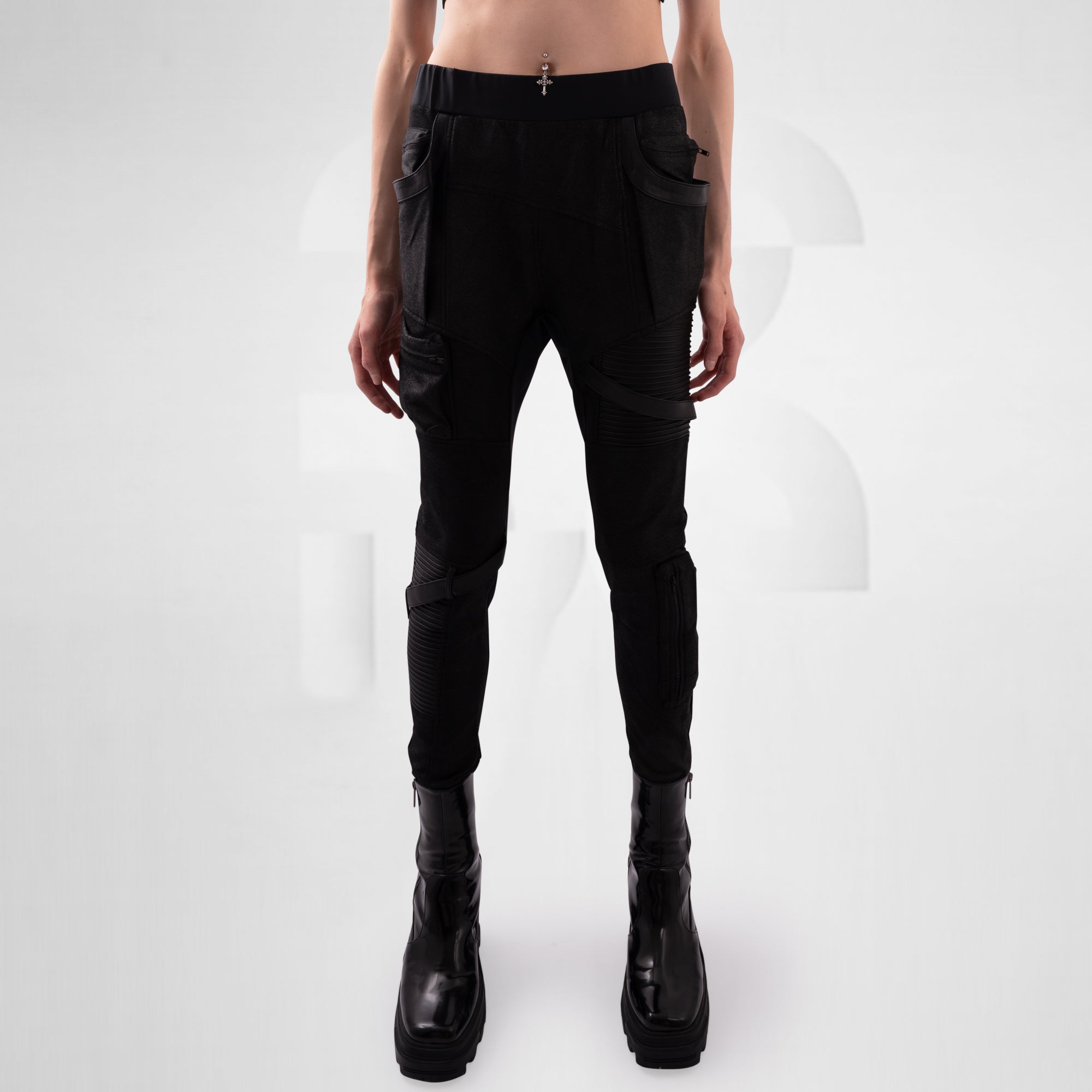 Person wearing black cargo pants and black boots on a white background
