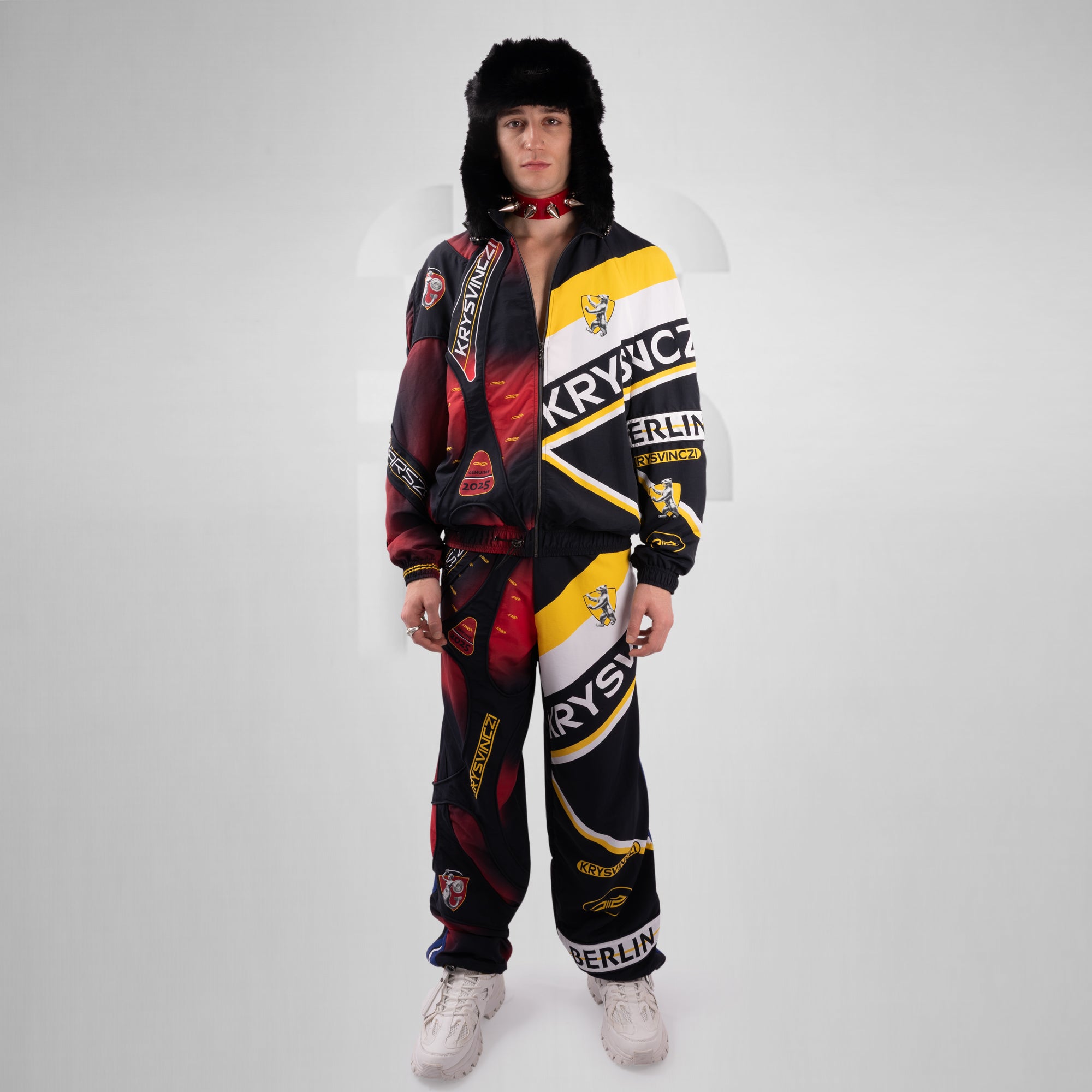 Person wearing a colorful onesie with brand logos on a white background