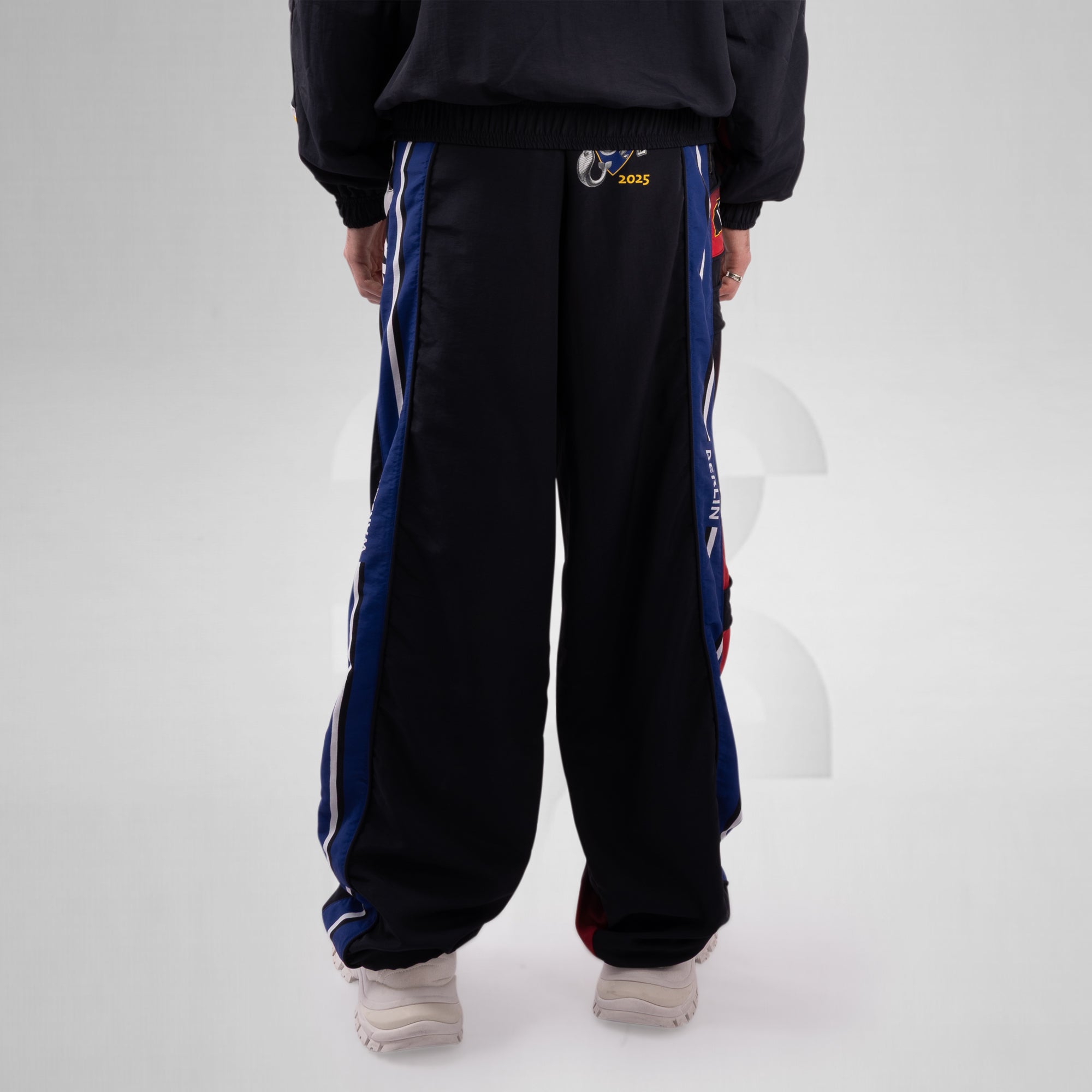 Black track pants with blue and white stripes on a white background