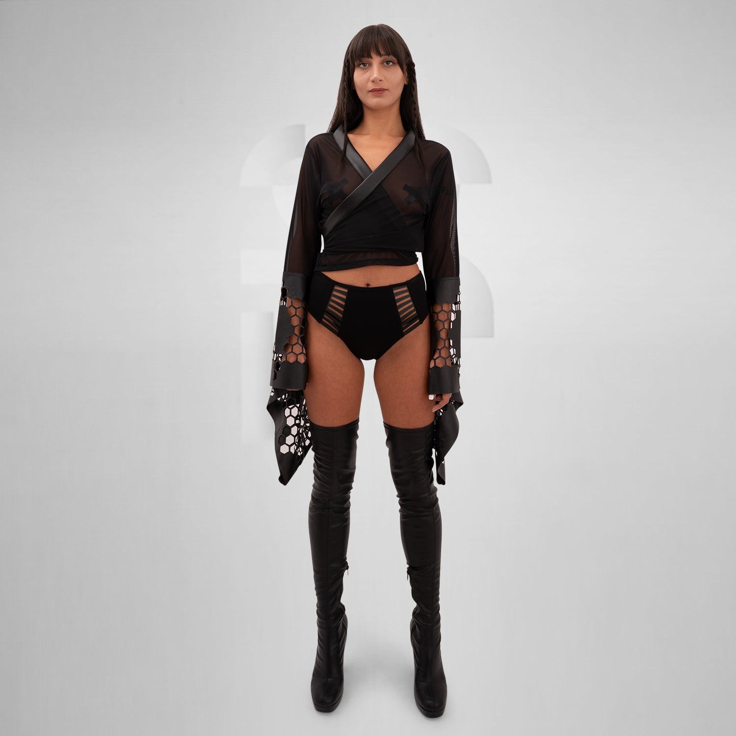 The Printed Sheer Kimono from Cyberesque is a stunning blend of elegance and edgy design. Featuring intricate laser-cut detailing on the sleeves and hem, this kimono adds a bold flair to any outfit. Crafted from lightweight, sheer fabric, it drapes beautifully, making it perfect for layering over clubwear or swimwear. Ideal for those who want to make a statement at festivals or embrace avant-garde fashion.