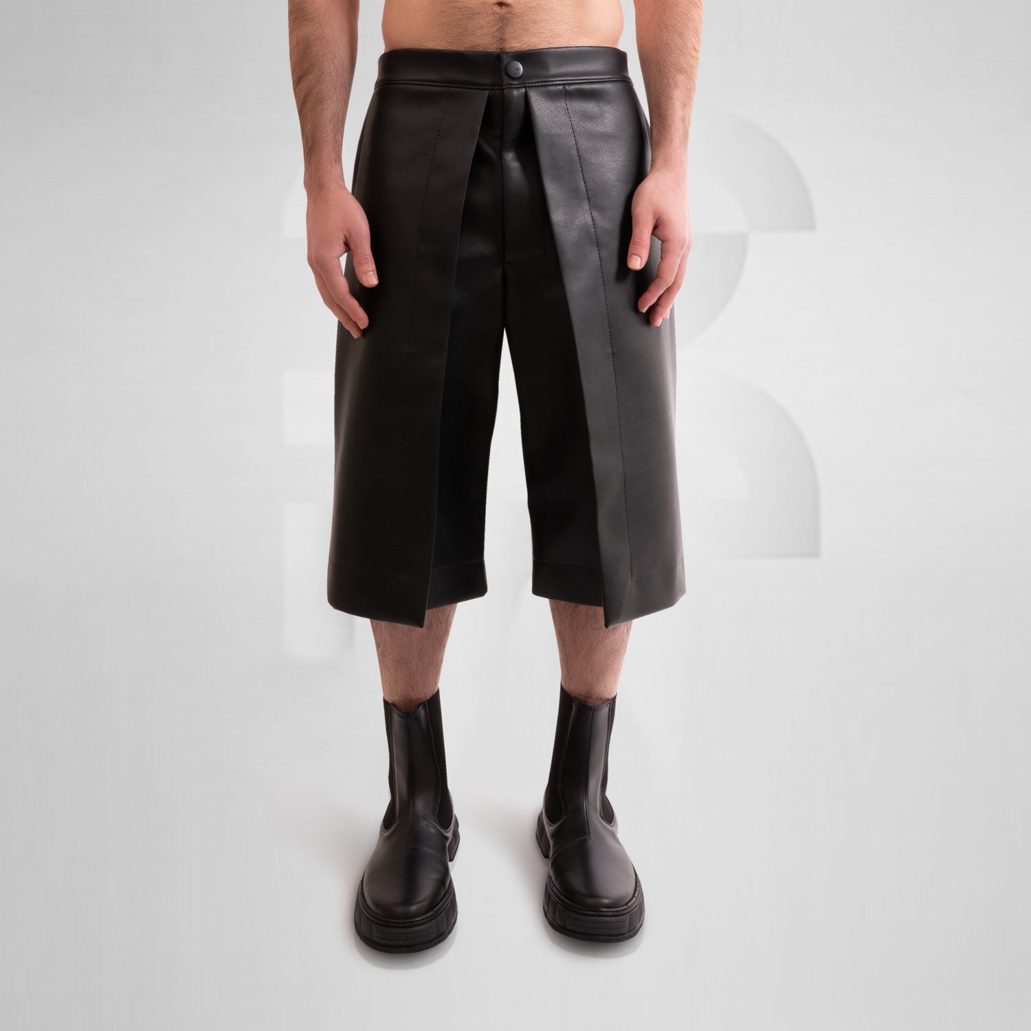 Image of a pair of avant-garde vegan leather pants with a unique layered geometric style.