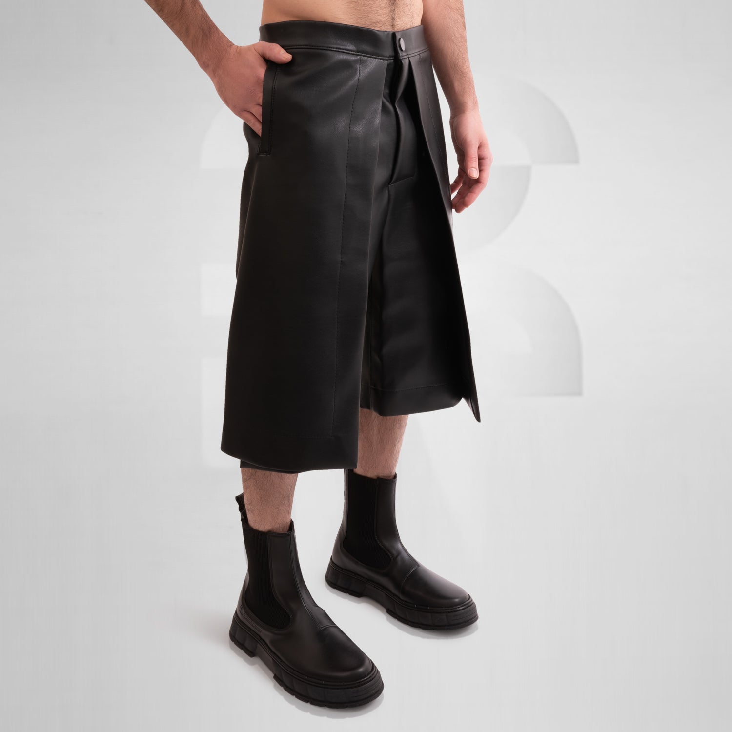 Image of a pair of avant-garde vegan leather pants with a unique layered geometric style.