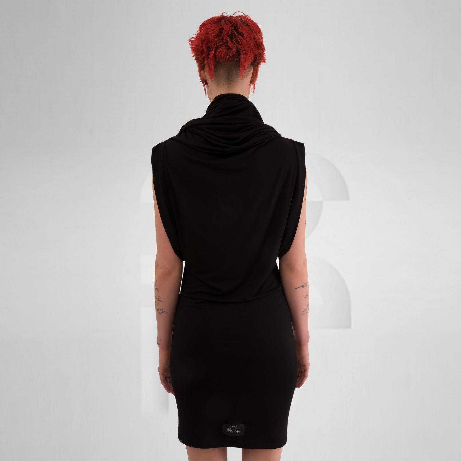 Black tube dress with unique neck detail that can be worn as a hoodie, creating an avant-garde look.