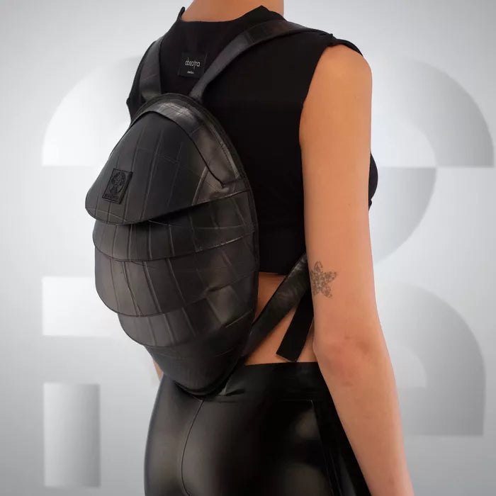 The Faux Leather Anti-Spy Backpack - crafted from 100% recycled rubber, featuring a waterproof zipper, anti-spy pocket, and secret compartment.