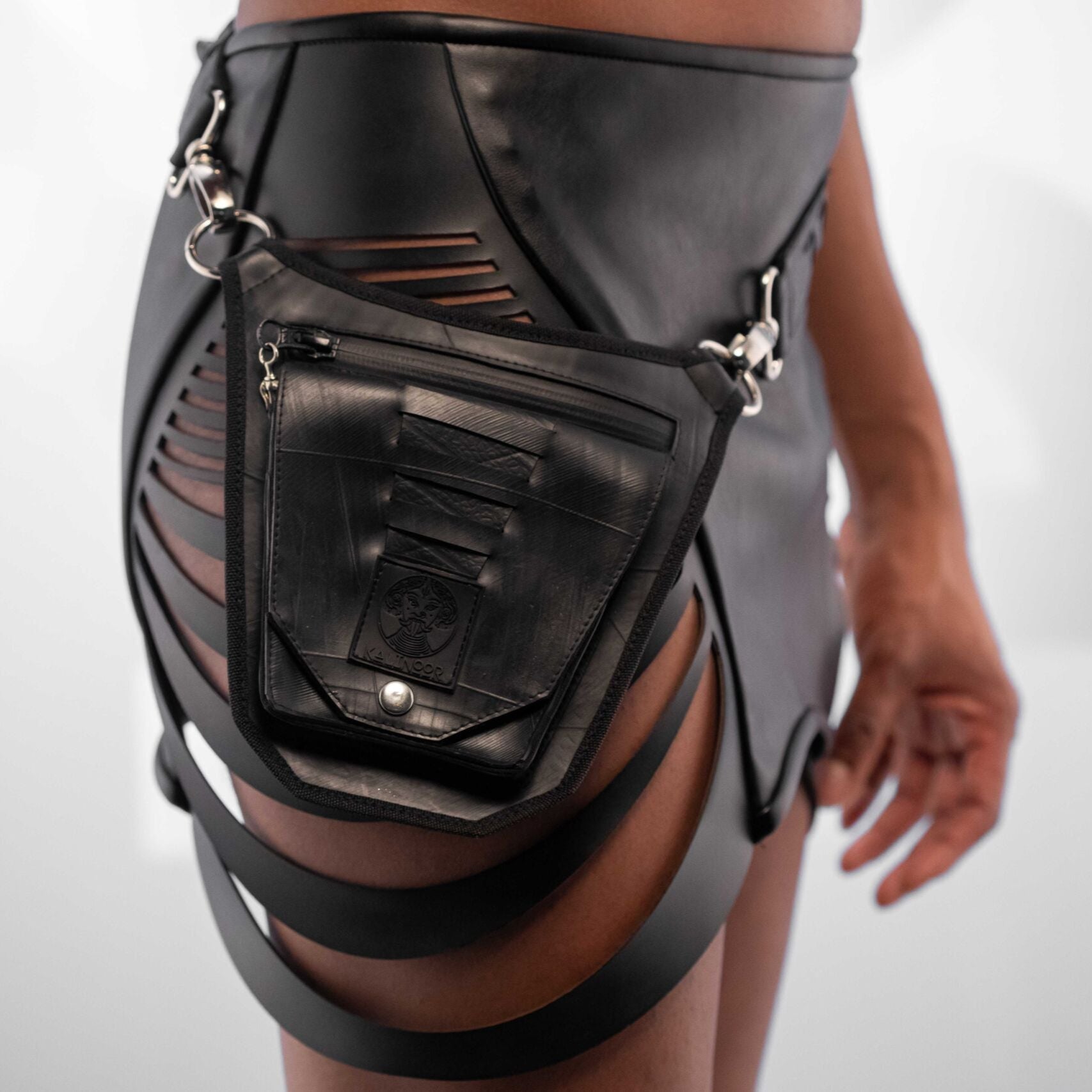 Close-up of the Kalinoor Rubber Hip Bag, featuring a unique recycled rubber exterior, sturdy denim interior, waterproof zipper with white brass detail, and a hidden anti-spy back pocket for secure storage.