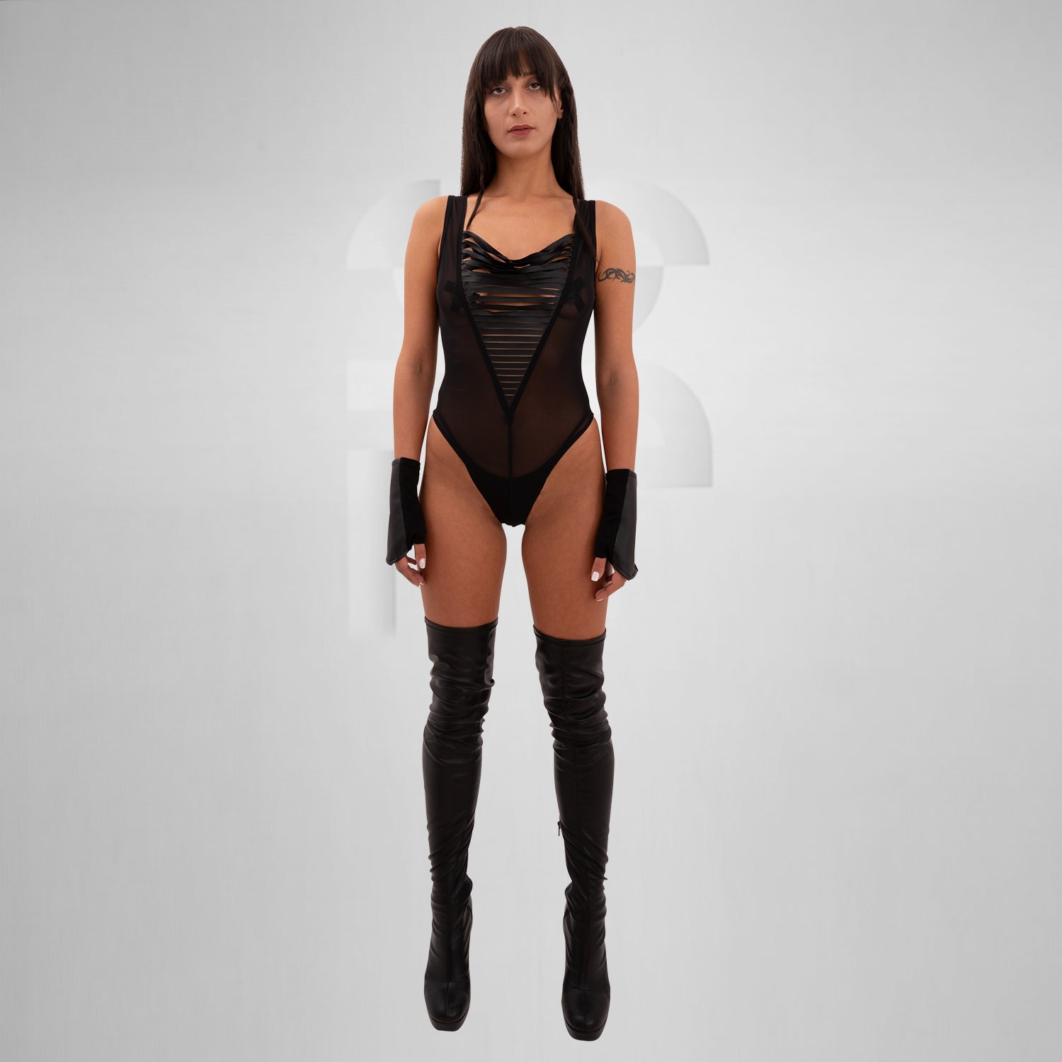 Sheer mesh bodysuit featuring bold vegan leather straps, designed for bold self-expression and dynamic style, perfect for festivals, clubs, and artistic gatherings.