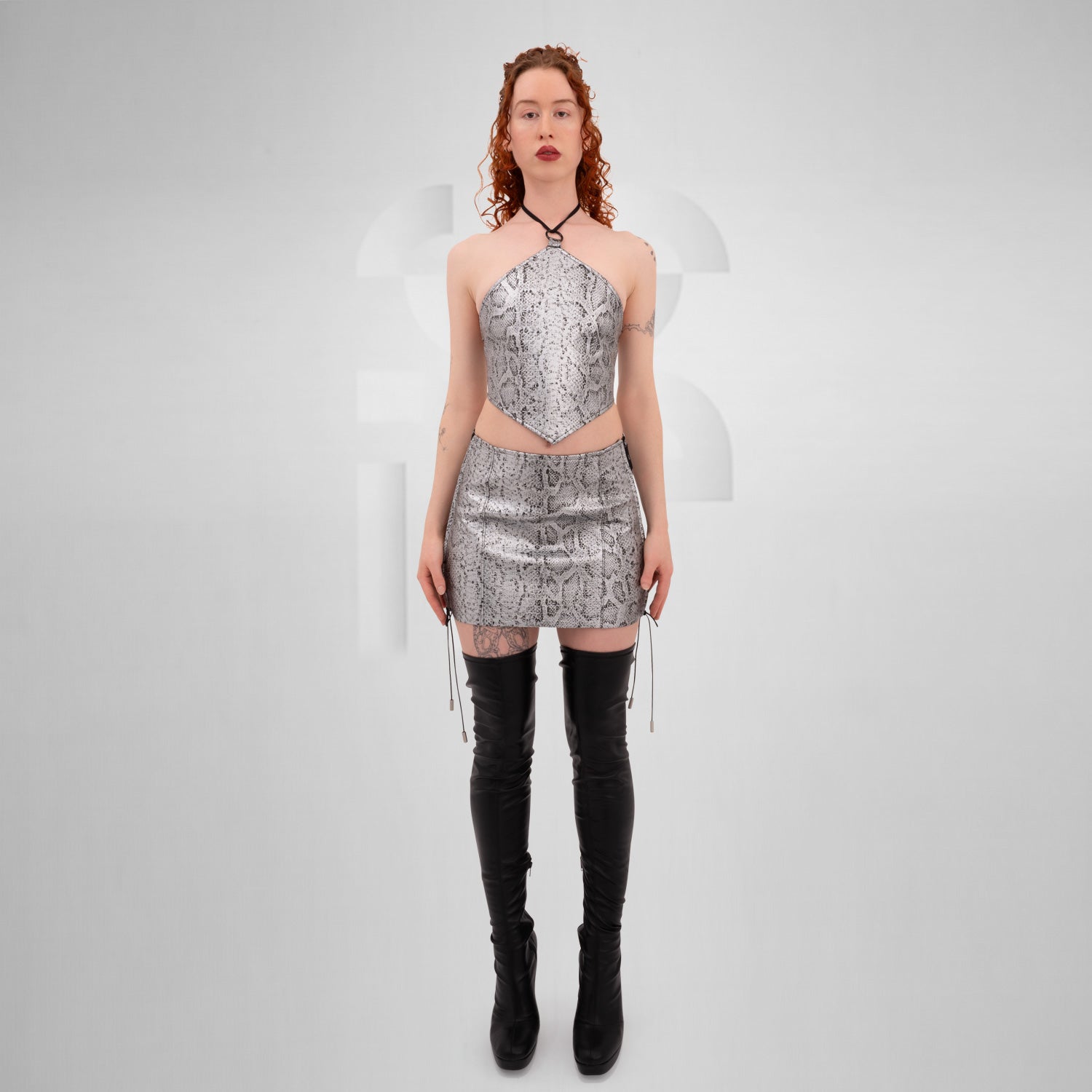 Silver PVC snake skin lace-up skirt, perfect for edgy outfits and nightlife.