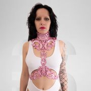 The pink latex harness with a baroque style exudes both elegance and playfulness. It is carefully crafted with intricate details that pay homage to the extravagant art movement of the Baroque period.