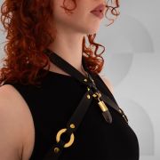 Vegan leather harness with metallic rings and crystal pendant in the center front