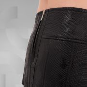 Mini skirt featuring a black PVC snake skin pattern with a back zipper, perfect for the Berlin club scene.